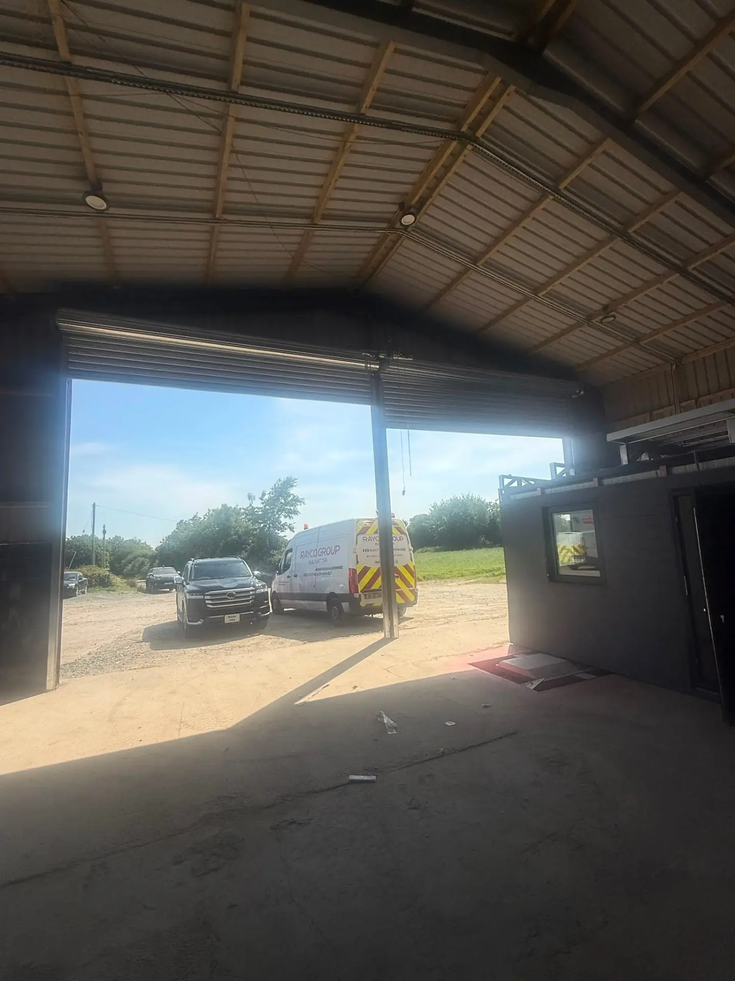 Completed commercial roller shutter installation with Rayco Group van on site